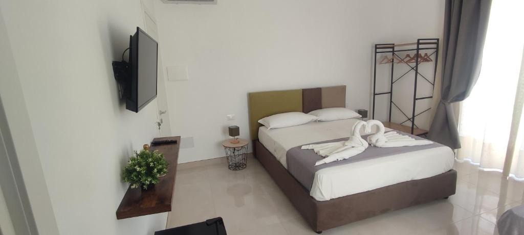 Postel nebo postele na pokoji v ubytování FeVi Rooms
