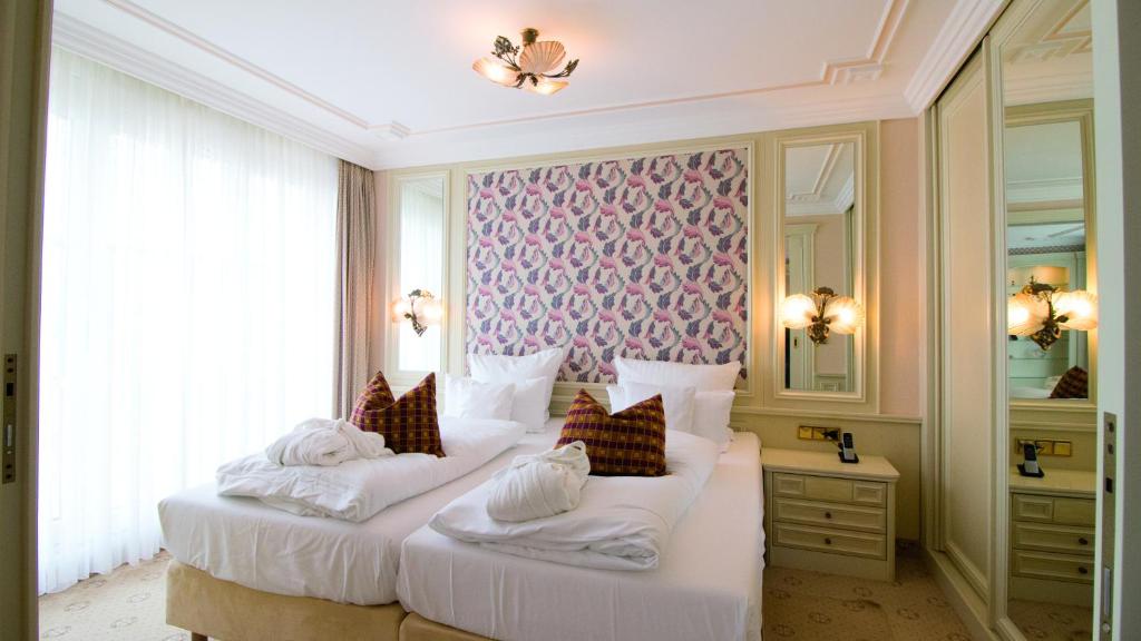 מיטה או מיטות בחדר ב-Seeschlößchen - Hotel Strandperle