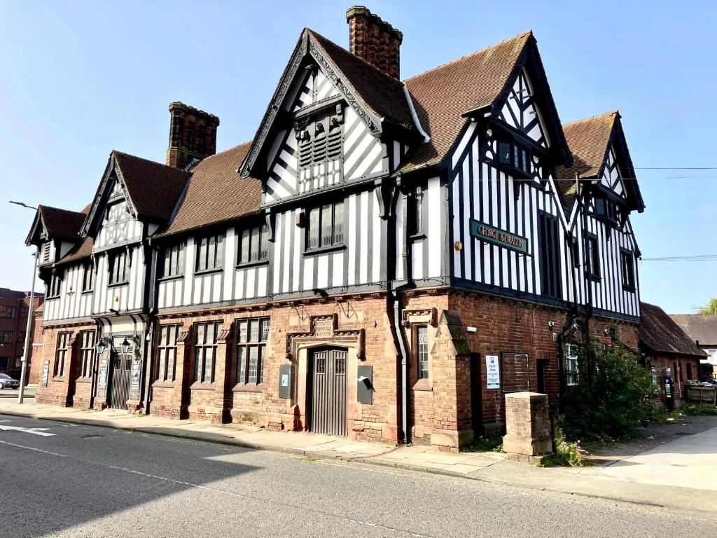 an old building on the corner of a street at George And Dragon Place in Chester