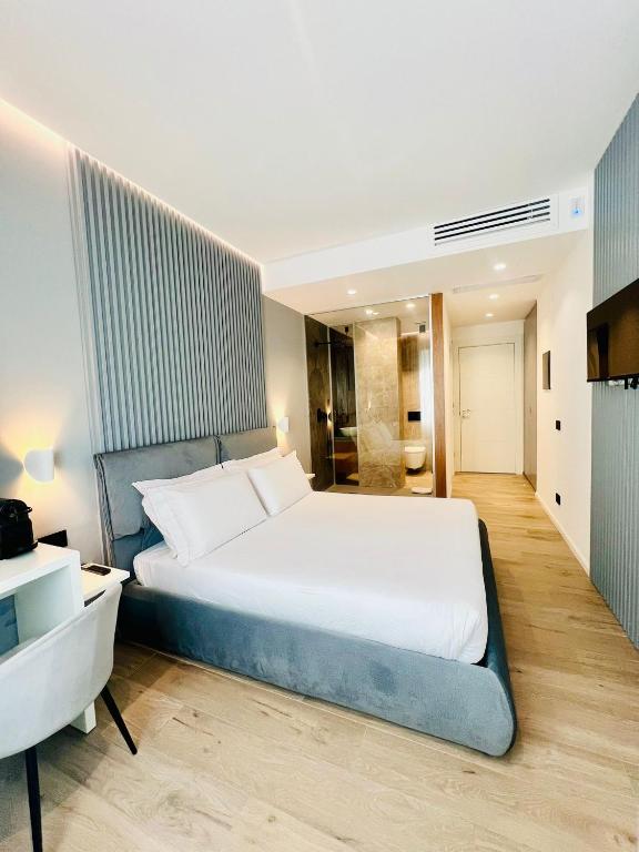 a bedroom with a large bed and a bathroom at La Chambre Milano in Milan
