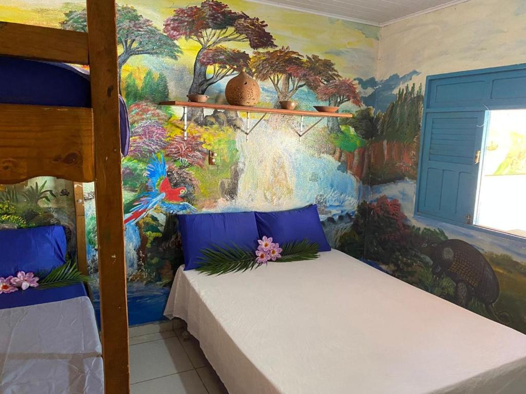 a bedroom with a painting on the wall at Casa Colorida in Prado