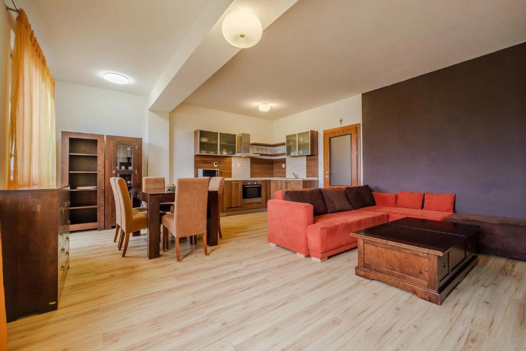 a living room with a couch and a table at Apartman Lomnica Tatry view C13 in Veľká Lomnica