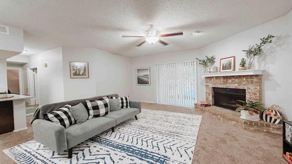 a living room with a couch and a fireplace at Spacious Family Value Retreat with Pool & Garage in Corpus Christi