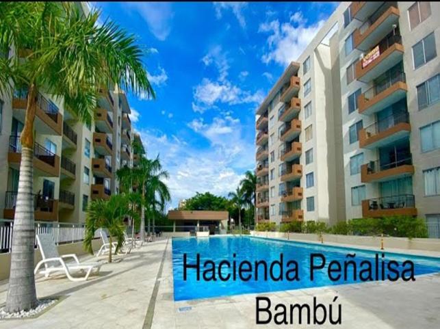a swimming pool in front of a building at Hacienda Peñalisa Bambu Girardot-Ricaurte in Soacha