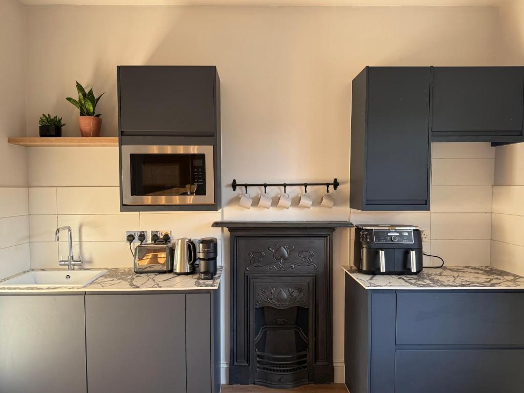 eine Küche mit Herd und Mikrowelle in der Unterkunft West Bridgford 2 Bed 2 Bathroom Apartment with parking in Nottingham