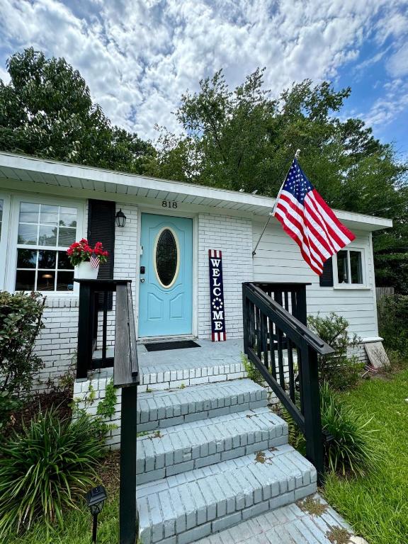 a house with a blue door and an american flag at Fort Freedom in Beaufort