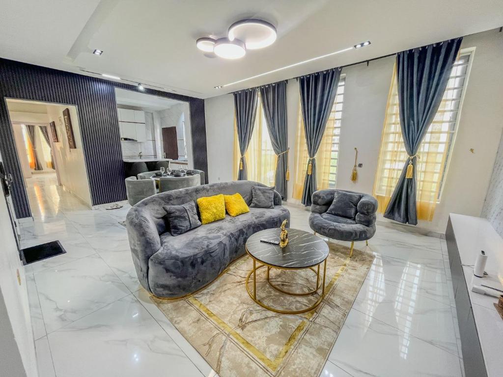 a living room with a couch and two chairs at Fully Furnished Luxury 2bedroom Apartment in Lekki