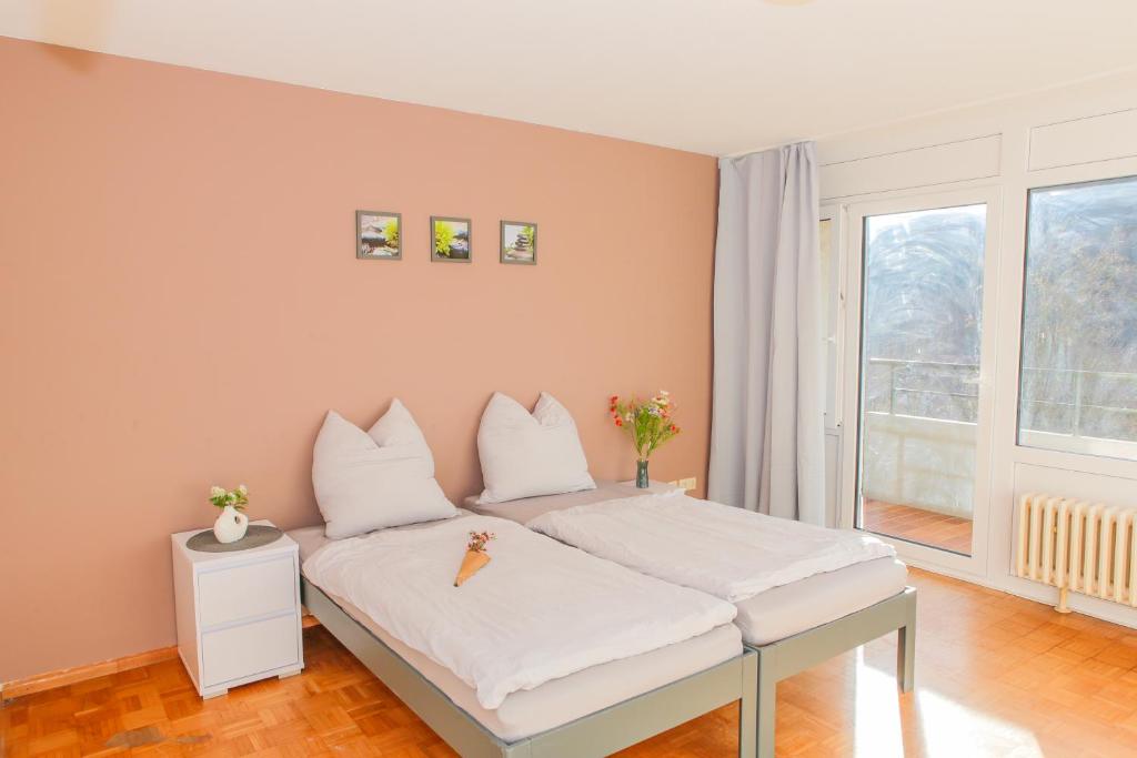 a bedroom with a bed with white sheets and pillows at GMA Apartment B12 in Lahr