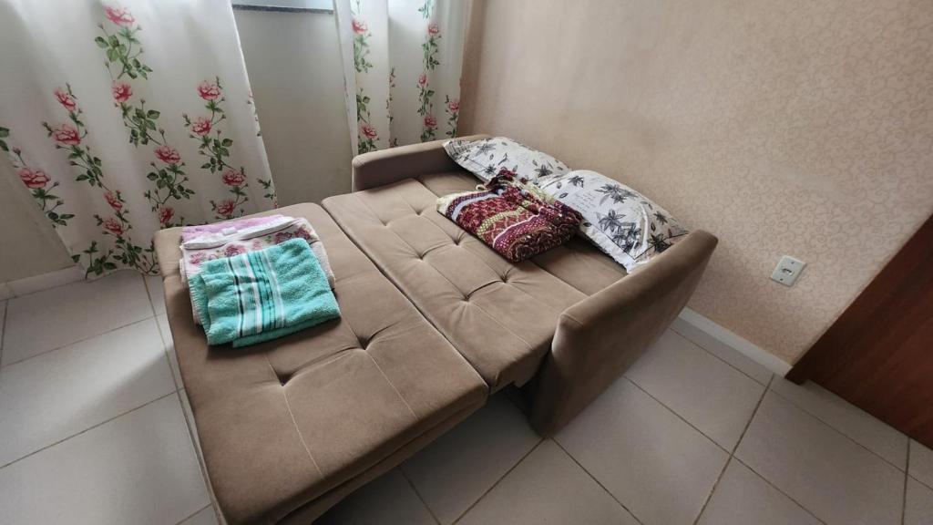 a brown couch with pillows on it in a room at Apt Mário Covas COP 30 in Belém