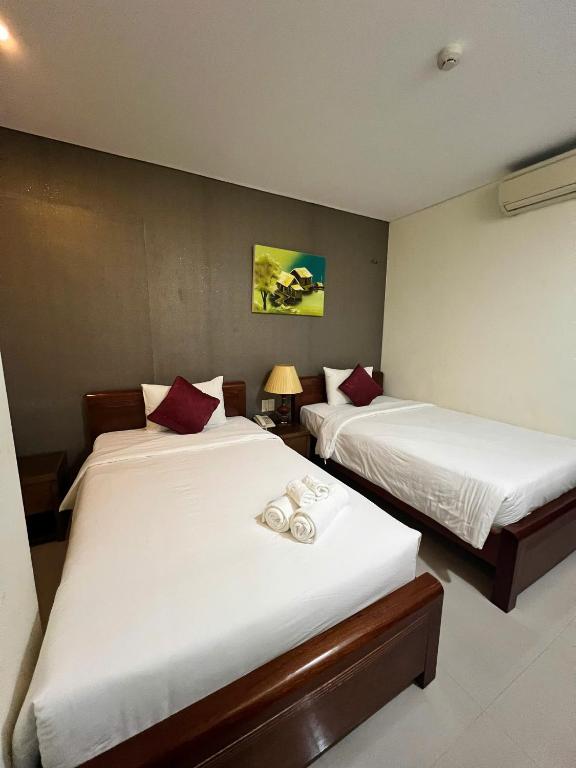 Voodi või voodid majutusasutuse Doha Central Bliss Danang Hotel by Haviland toas