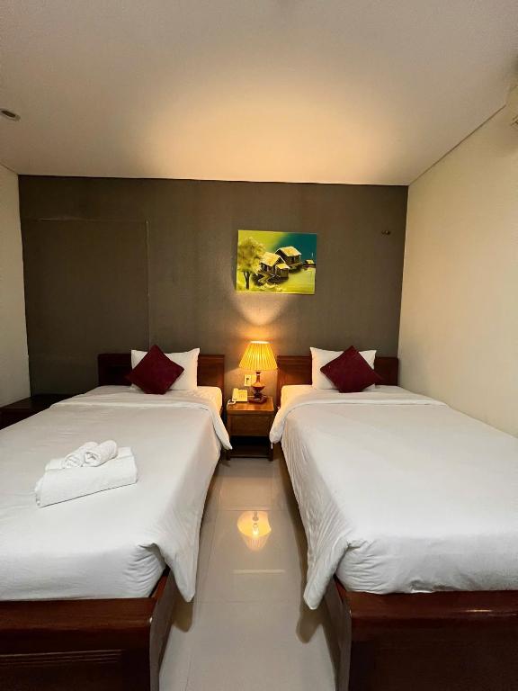 Voodi või voodid majutusasutuse Doha Central Bliss Danang Hotel by Haviland toas