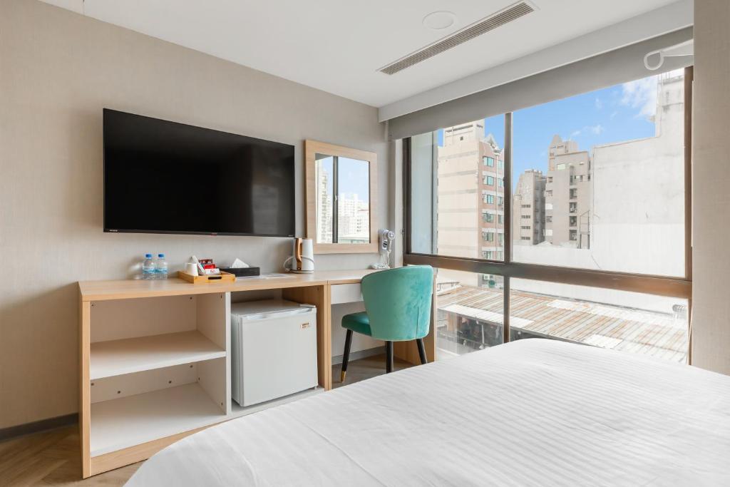 TV a/nebo společenská místnost v ubytování Mu Chen Hotel