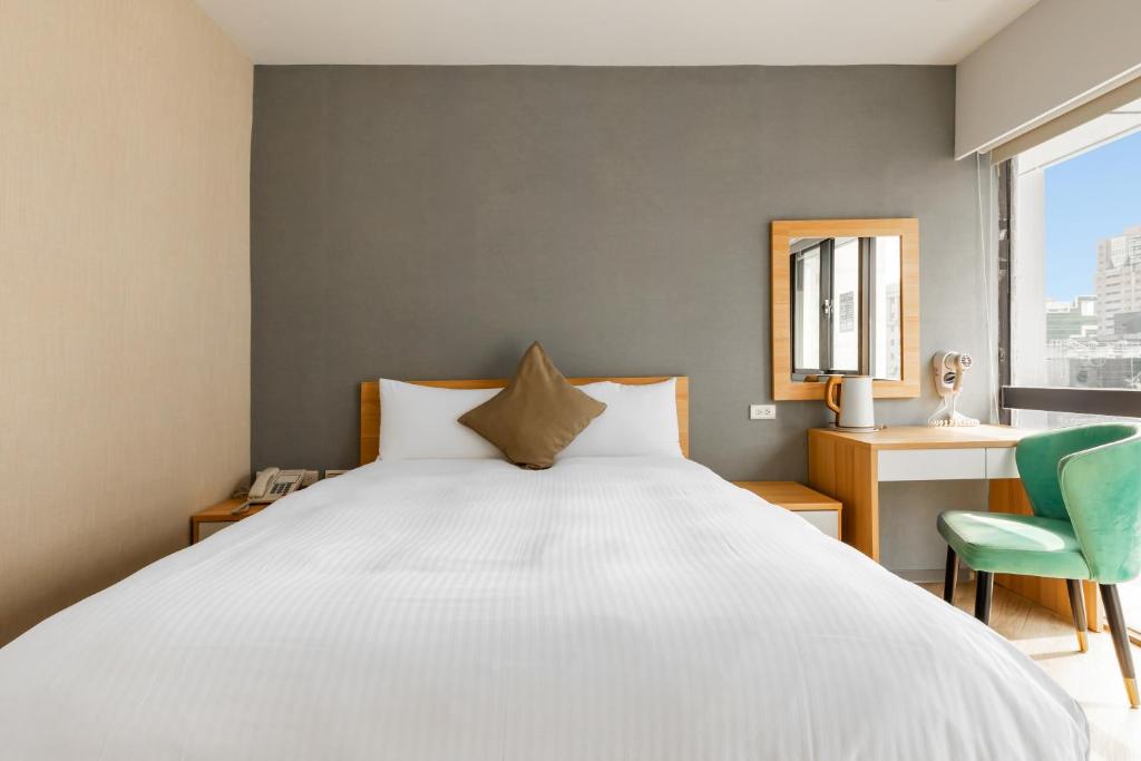 Postel nebo postele na pokoji v ubytování Mu Chen Hotel