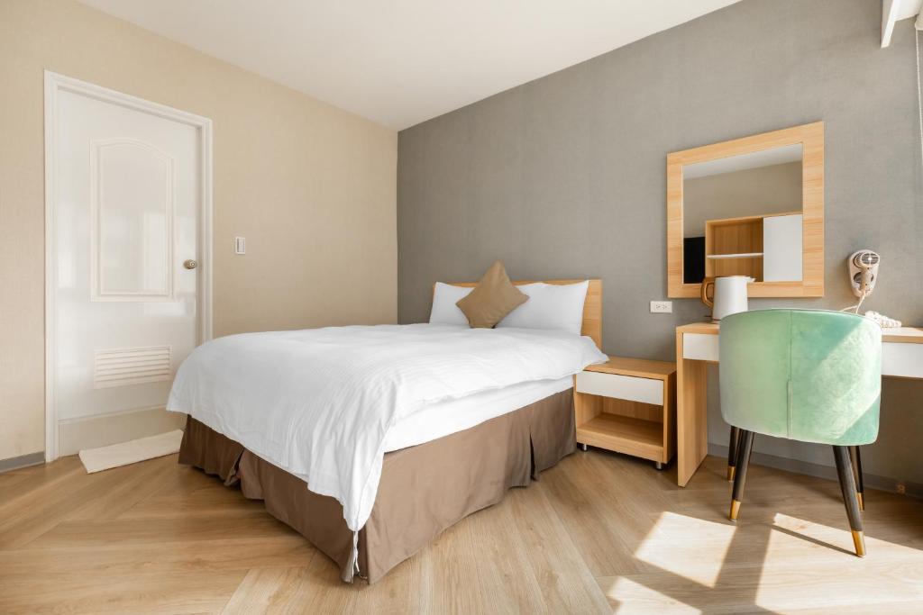 Postel nebo postele na pokoji v ubytování Mu Chen Hotel