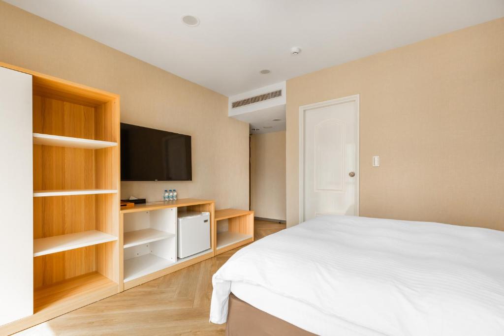 Postel nebo postele na pokoji v ubytování Mu Chen Hotel