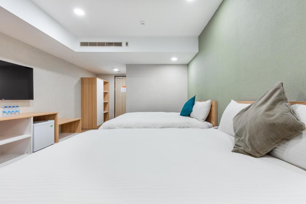 Postel nebo postele na pokoji v ubytování Mu Chen Hotel