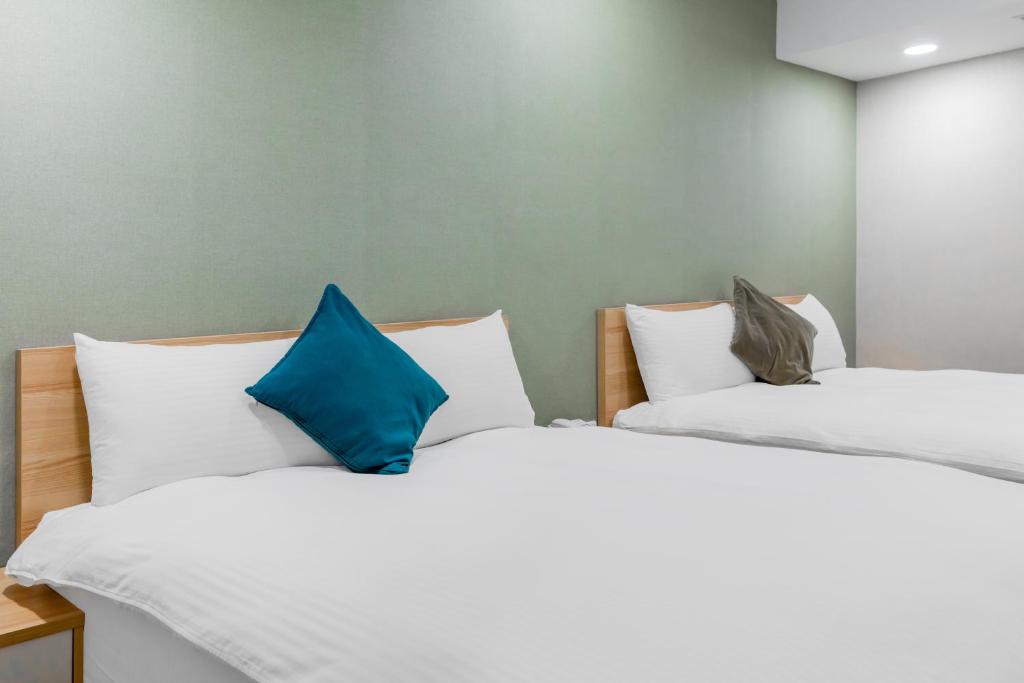 Postel nebo postele na pokoji v ubytování Mu Chen Hotel