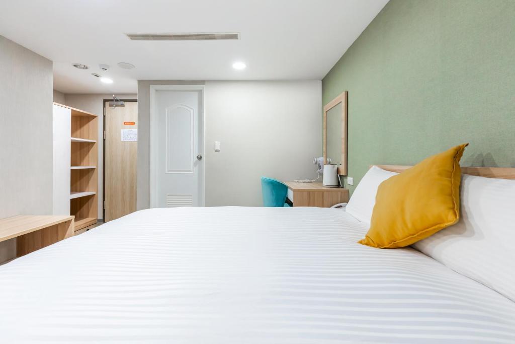 Postel nebo postele na pokoji v ubytování Mu Chen Hotel