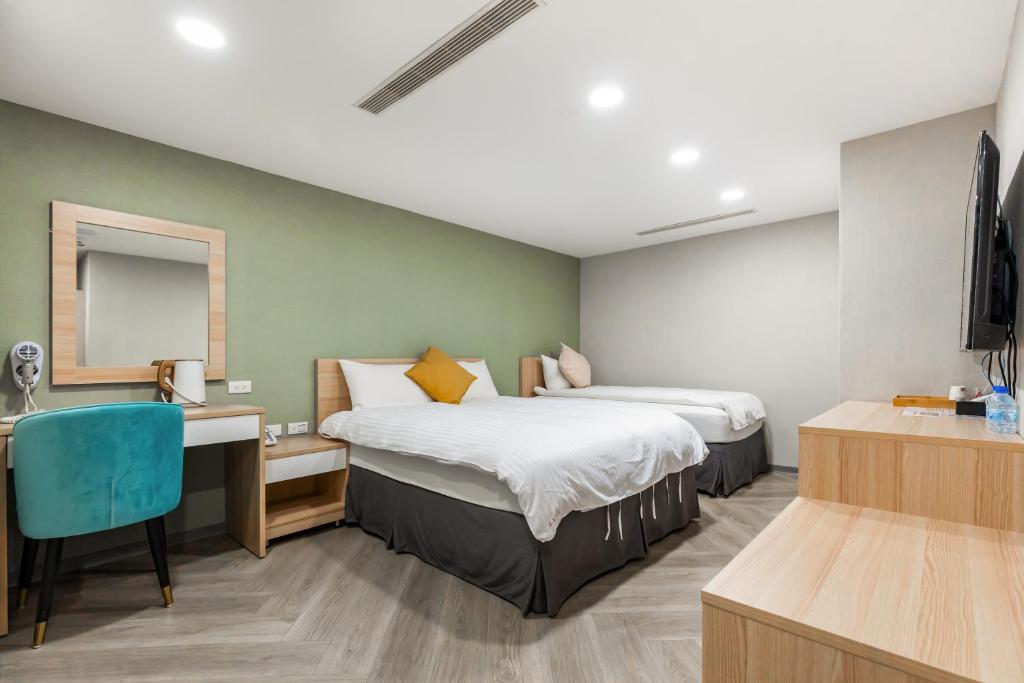 Postel nebo postele na pokoji v ubytování Mu Chen Hotel