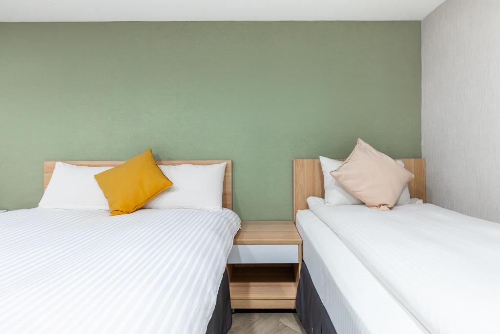 Postel nebo postele na pokoji v ubytování Mu Chen Hotel