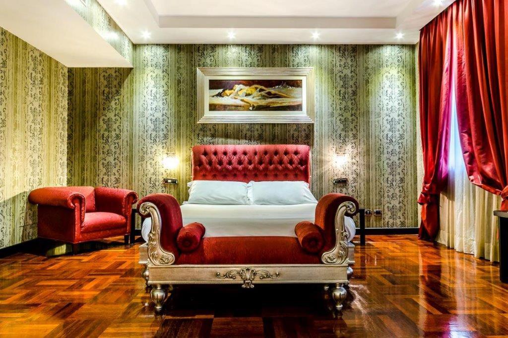 1 dormitorio con cama roja y silla roja en Hotel Silver Milano, en Milán