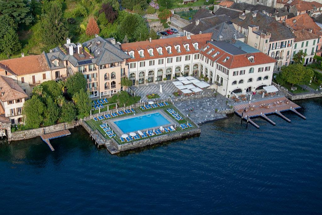 a large body of water surrounded by buildings at Hotel San Rocco in Orta San Giulio