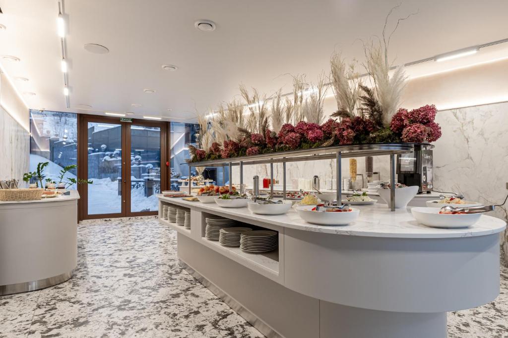 a buffet line in a restaurant with bowls of food at MARION SPA Hotel & Spa - RENOVATION - Rooms, SPA area, Swimming pool, Reception, Restaurant, Lounge Bar, Hookah bar, Children's room, Parking, SPA and Breakfast included in the price in Bukovel