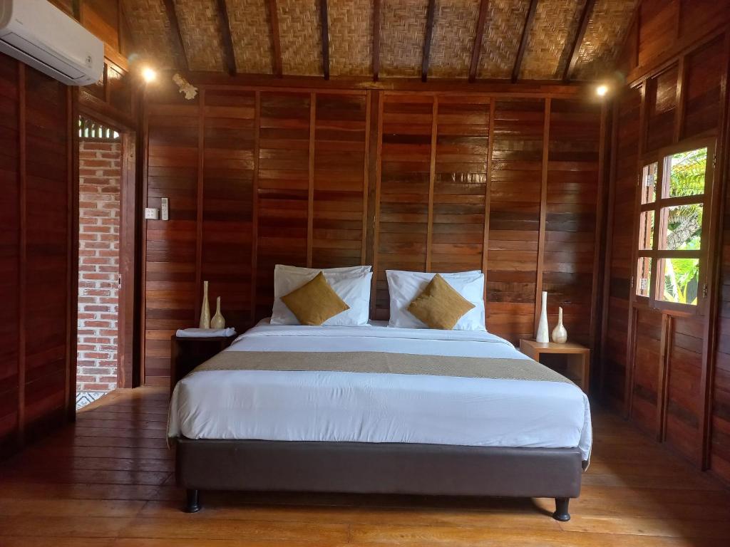 Postel nebo postele na pokoji v ubytování Mahayana Guest House