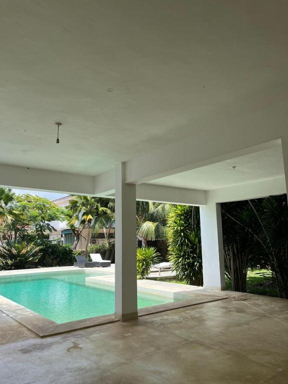 a swimming pool in the middle of a house at Ripasso Bed & Breakfast in Malindi