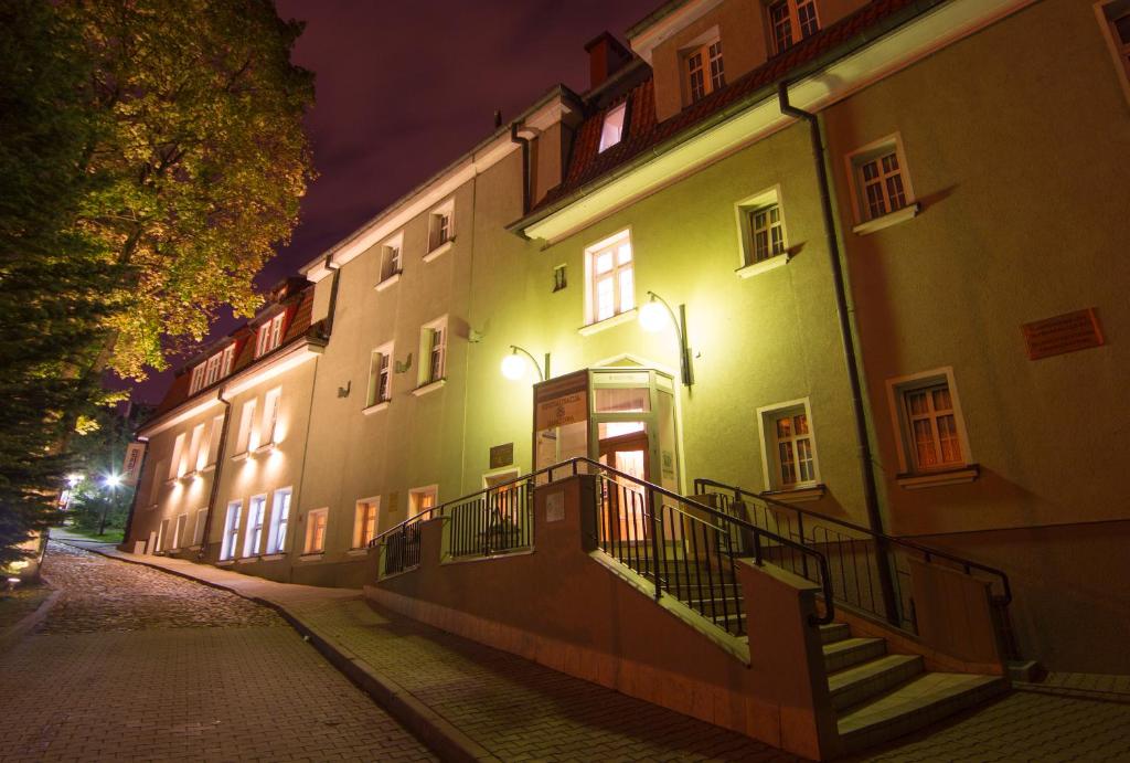 a building with stairs on a street at night at Centrum25 in Olsztyn