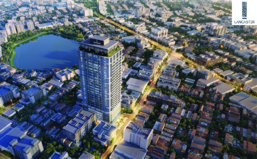an aerial view of a tall building in a city at SIMI Homes Lancaster 24 Cozy Studio for 4 in Luxury Building with Heated Pool, Fitness and Spa Hanoi Center in Hanoi