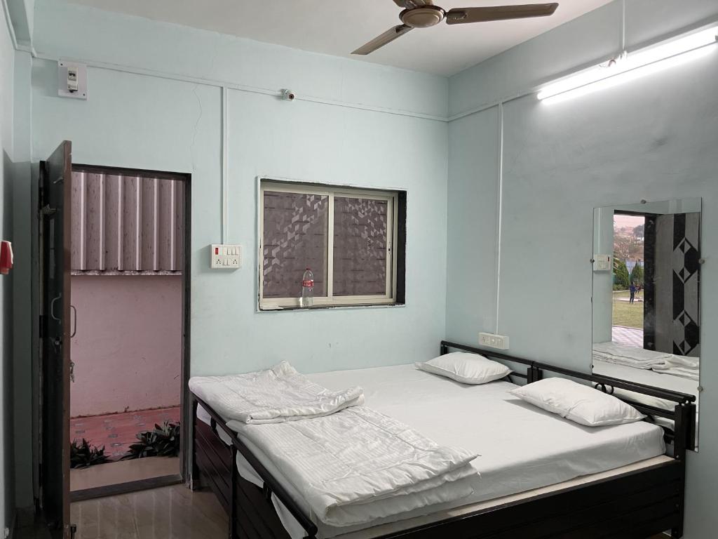 En eller flere senge i et værelse på Fulgulab Lawns and Home Stay