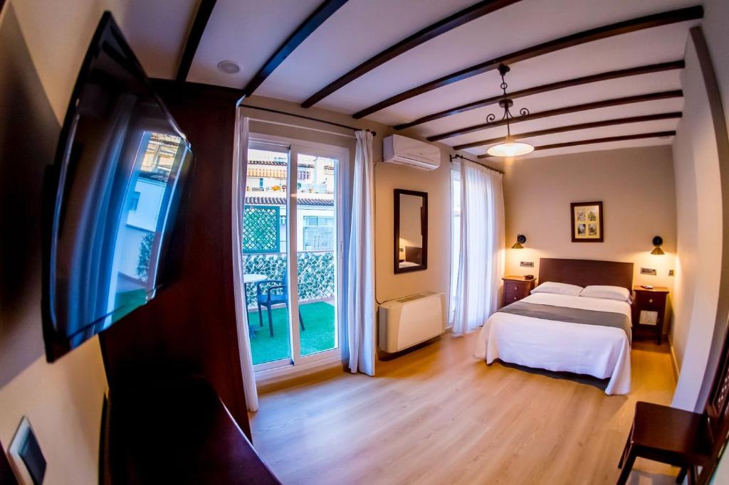 Postel nebo postele na pokoji v ubytování Hotel Tharsis