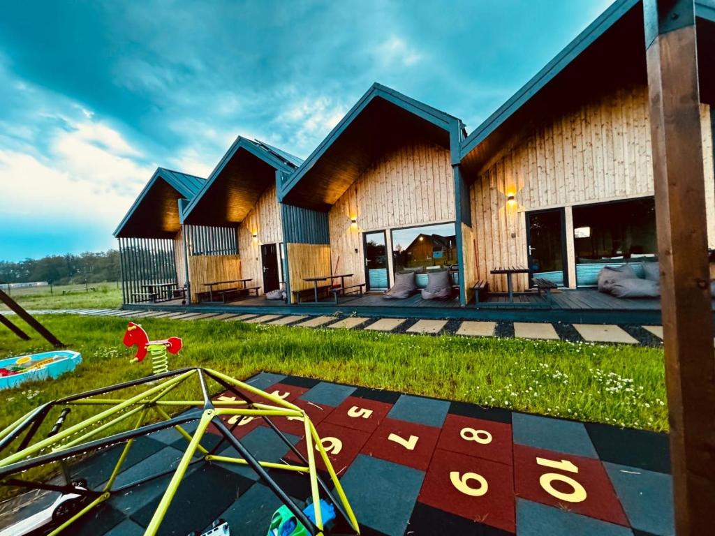 a building with a playground in front of it at Sunmare in Sarbinowo