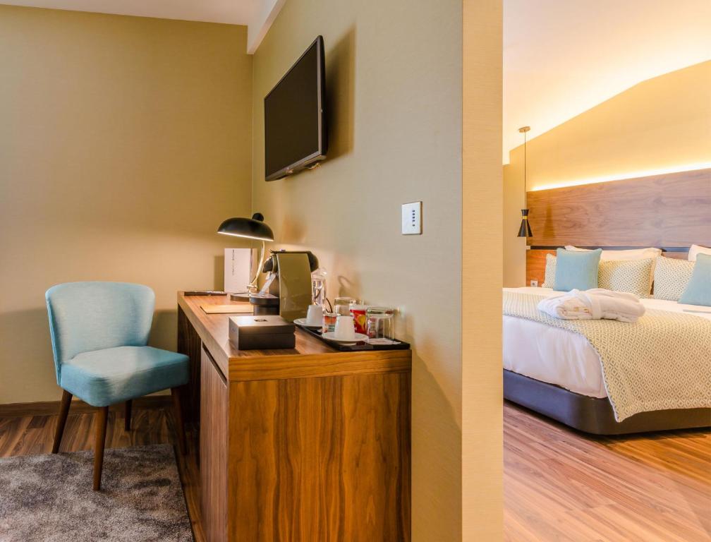 A compact in-room work and refreshment station beside the bed.