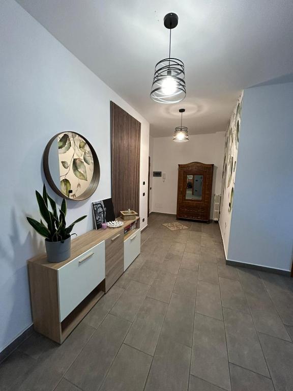 a hallway with a desk and a mirror on the wall at 4 Piano Apartment in Laveno-Mombello