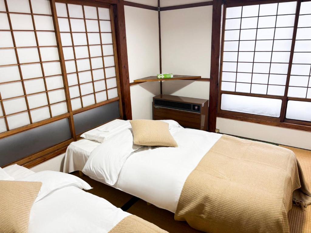 Postel nebo postele na pokoji v ubytování 湯沢石打ホテルNozomi
