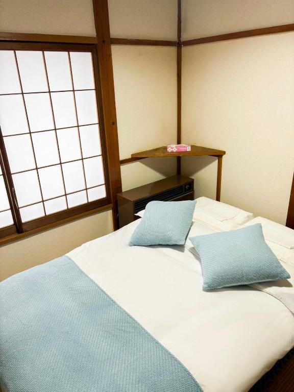 Postel nebo postele na pokoji v ubytování 湯沢石打ホテルNozomi
