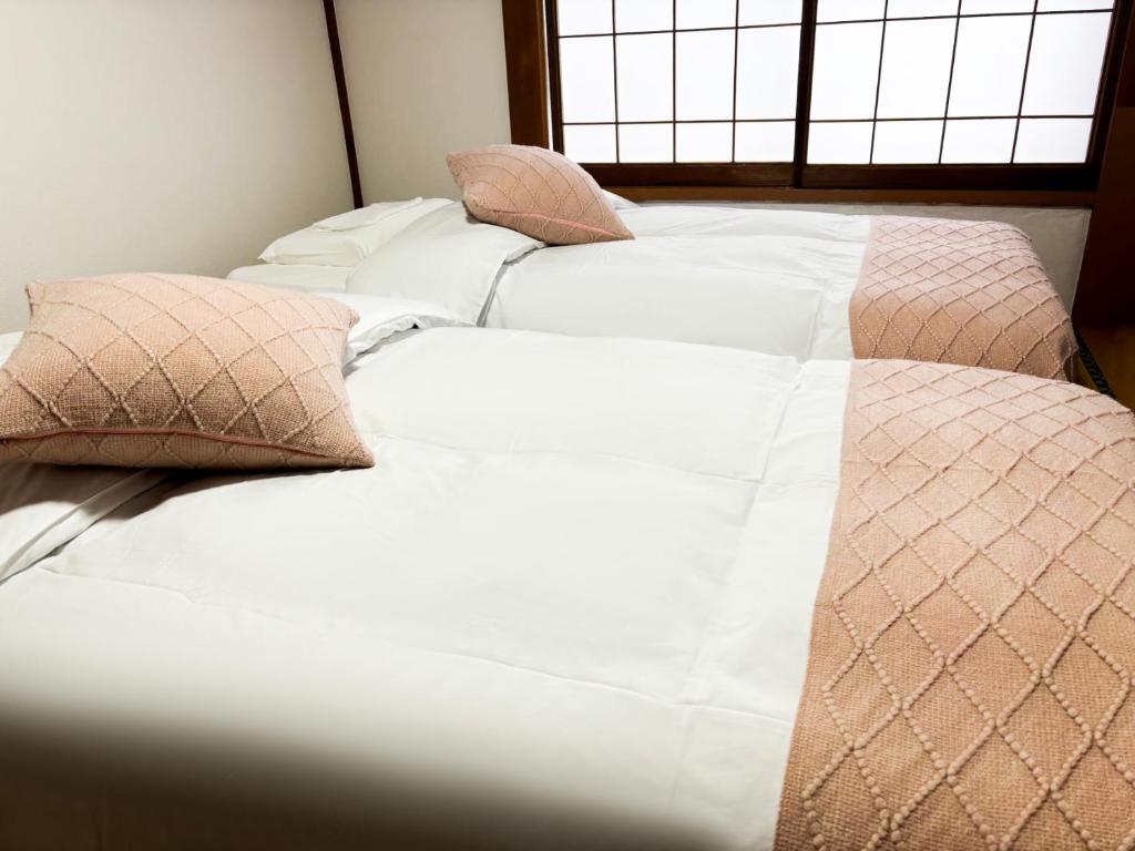 Postel nebo postele na pokoji v ubytování 湯沢石打ホテルNozomi