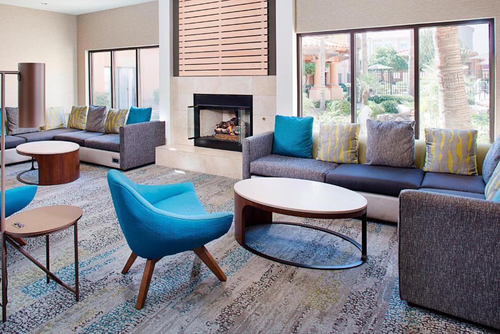 a living room with couches and chairs and a fireplace at Courtyard by Marriott Tucson Williams Centre in Tucson