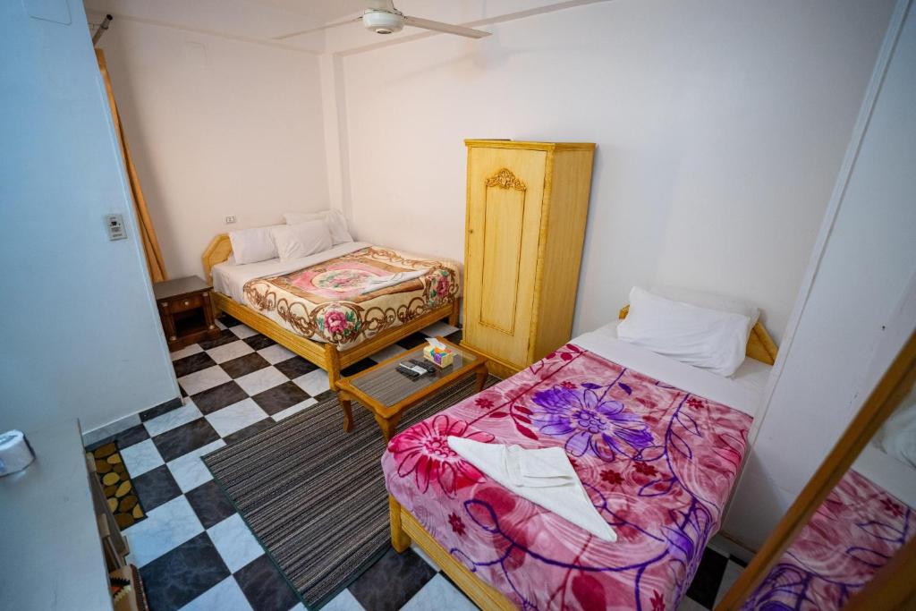Postel nebo postele na pokoji v ubytování Venus Hotel Luxor 日本人 大歓迎