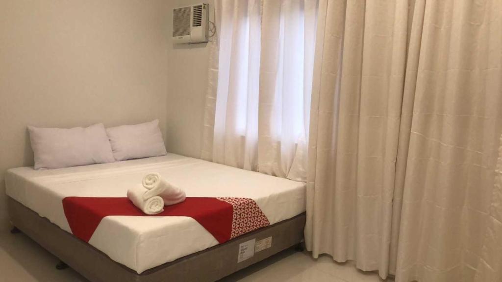 Postel nebo postele na pokoji v ubytování OYO 1128 Hotel Sangco