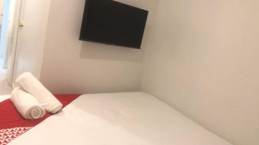 Postel nebo postele na pokoji v ubytování OYO 1128 Hotel Sangco
