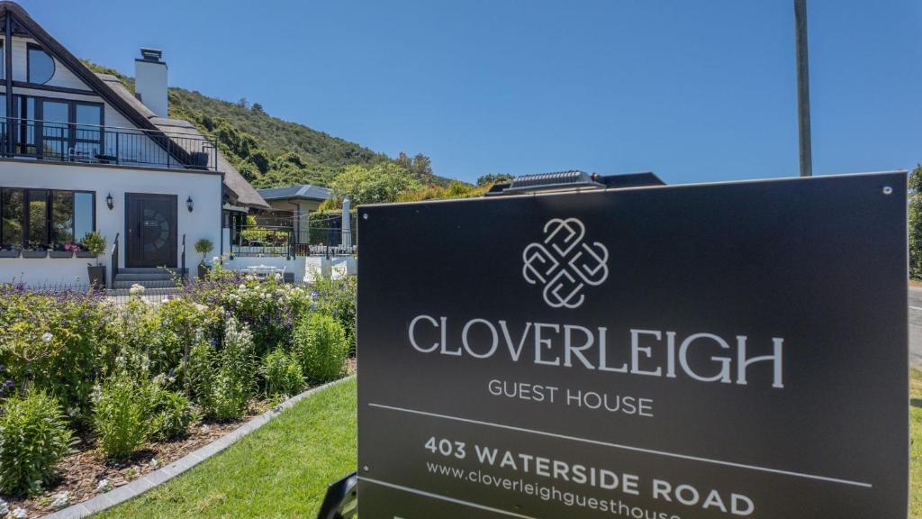a sign for a guest house in front of a house at Cloverleigh Guest House in Wilderness