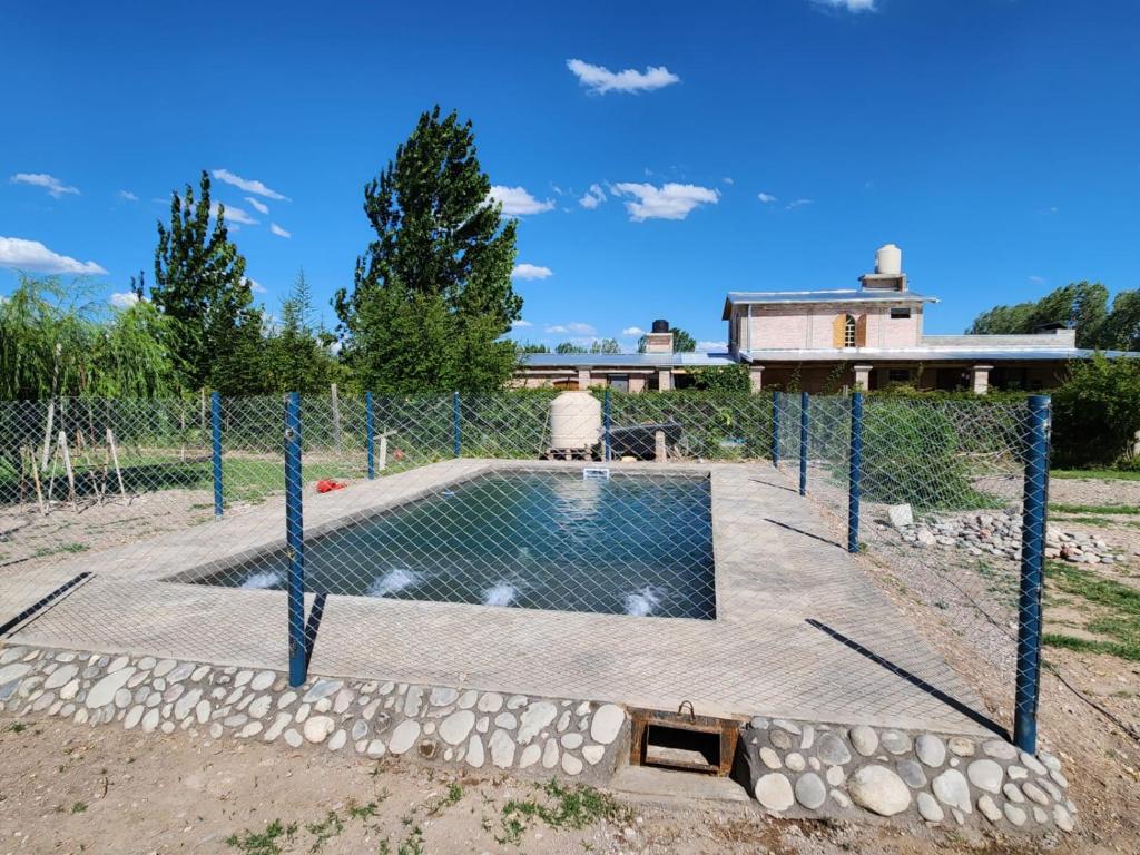 a swimming pool with a fence around it at Cabañas Alicia in San Rafael
