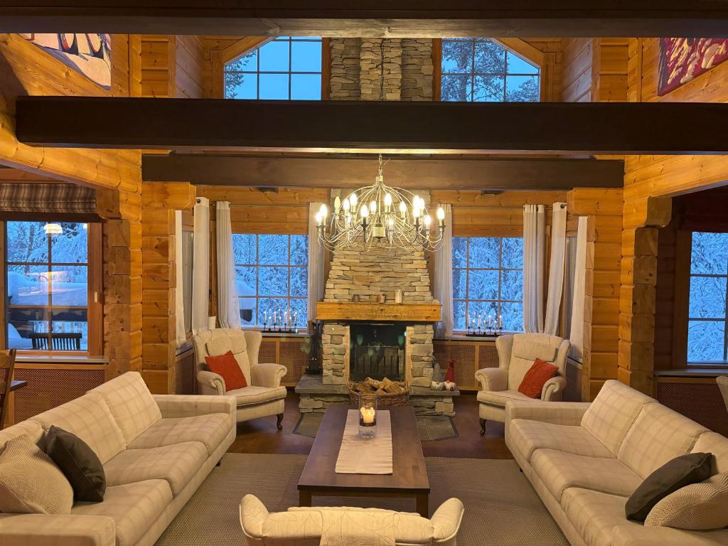 a living room with couches and a fireplace at Villa Vielma in Levi