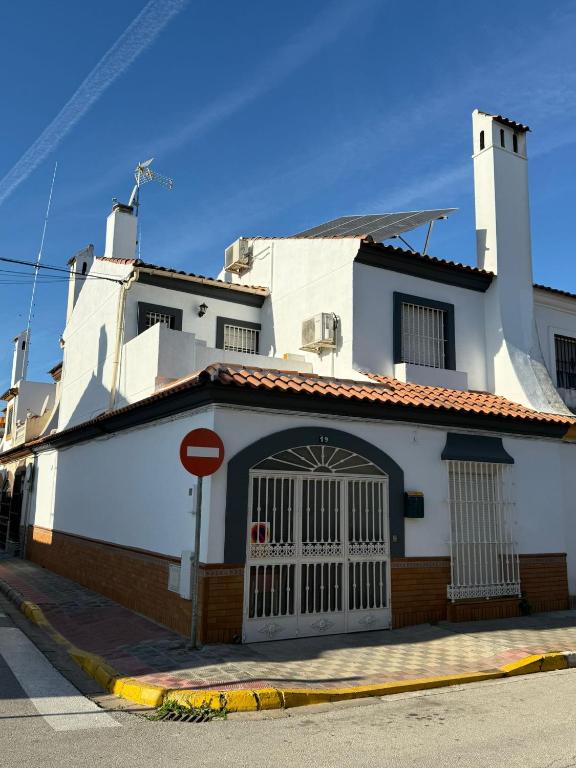a white building with a door on a street at Like Home in Dos Hermanas