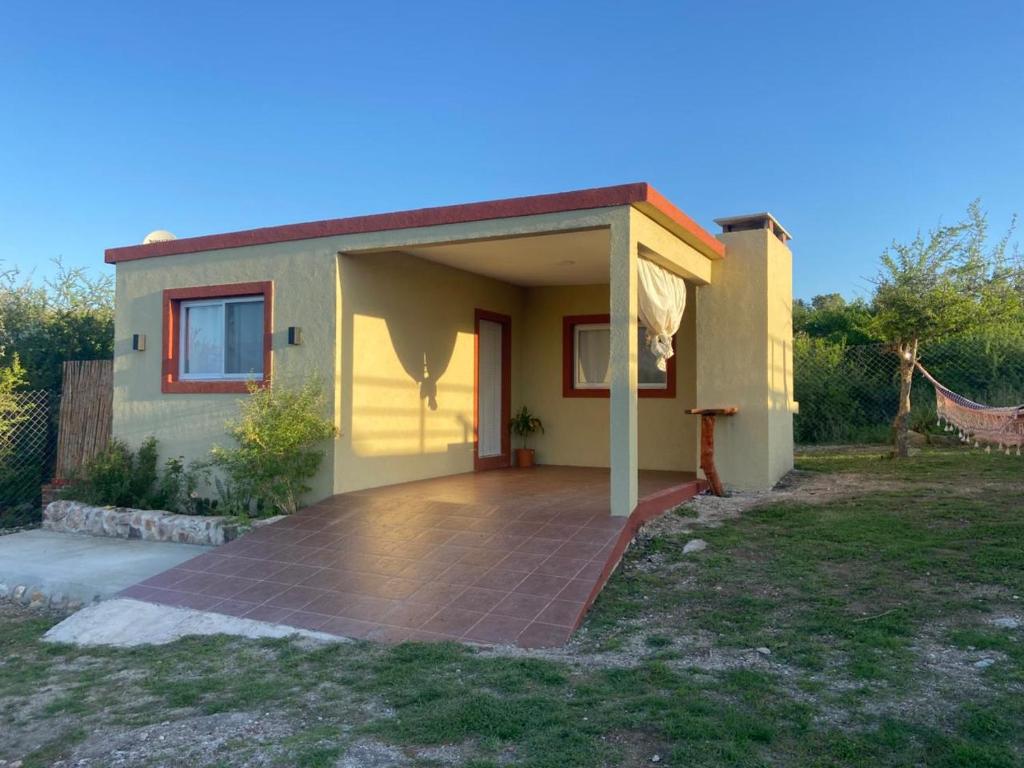 a small house with a patio in front of it at Cabañas Vicentico in Mina Clavero