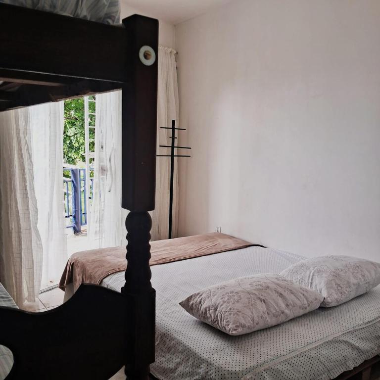 Postel nebo postele na pokoji v ubytování Independent suite obs aluguel apenas do comodo independente não consigo alterar a informacão casa de 1 quarto é automática da plataforma
