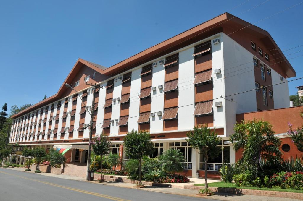 a large building with a brown and white facade at Hotel Majestic in Águas de Lindóia